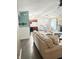 Bright and airy living space with hardwood floors and an open floor plan that connects to the kitchen at 7916 Begonia Ct, Indianapolis, IN 46113
