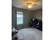 Living room with neutral walls, fan and natural light from the window at 7916 Begonia Ct, Indianapolis, IN 46113