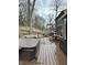 Backyard deck featuring a sunken hot tub, ample seating, mature landscaping, and a tranquil backyard retreat at 8224 Claridge Rd, Indianapolis, IN 46260