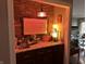 Charming bar area with stone accents, custom lighting, and decorative artwork at 8224 Claridge Rd, Indianapolis, IN 46260
