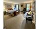 Large bedroom with a king-size bed, a reading chair, and lots of natural light from large windows at 8224 Claridge Rd, Indianapolis, IN 46260