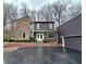 Striking two-story home featuring a blend of stone and contemporary siding, accentuated by mature trees and professional landscaping at 8224 Claridge Rd, Indianapolis, IN 46260