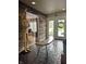 Inviting foyer features a decorative bench and unique flooring leading to the front door, with views into other rooms at 8224 Claridge Rd, Indianapolis, IN 46260