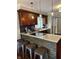 Modern kitchen with dark wood cabinets, stone backsplash, granite counters and seating at the breakfast bar at 8224 Claridge Rd, Indianapolis, IN 46260