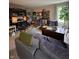 Cozy living room featuring a sofa, throw blanket, hardwood chest, and a tree near the window at 8224 Claridge Rd, Indianapolis, IN 46260
