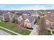 An elevated view of a stately brick home with well-kept lawn in a lush, green neighborhood at 9880 Wading Crane Ave, Fishers, IN 46055