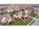 Expansive aerial view of a beautiful two-story brick home with mature landscaping and a backyard pool in a residential neighborhood at 9880 Wading Crane Ave, Fishers, IN 46055
