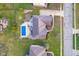 Aerial top-down view showcasing a home with a backyard swimming pool and concrete patio at 9880 Wading Crane Ave, Fishers, IN 46055