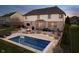 A backyard oasis featuring an in-ground swimming pool, fire pit, and ample space for outdoor lounging and entertaining at 9880 Wading Crane Ave, Fishers, IN 46055