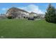 Expansive backyard has a well-manicured lawn, pool, fire pit, and outdoor seating at 9880 Wading Crane Ave, Fishers, IN 46055