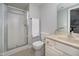 Well-lit bathroom has a glass enclosed shower, neutral tiling, and a classic vanity at 9880 Wading Crane Ave, Fishers, IN 46055