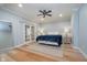 Calm bedroom features plush bedding, soft lighting, and French doors for a tranquil retreat at 9880 Wading Crane Ave, Fishers, IN 46055