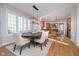 Well-lit dining area with modern chandelier, large windows, and access to the kitchen, perfect for gatherings at 9880 Wading Crane Ave, Fishers, IN 46055