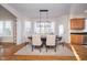 Bright dining room with an elegant light fixture and a large window that provides plenty of natural light at 9880 Wading Crane Ave, Fishers, IN 46055