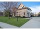 Charming two-story brick home with well-manicured lawn and landscaped garden beds at 9880 Wading Crane Ave, Fishers, IN 46055