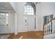 Bright foyer with large windows, hardwood floors, and elegant trim offering a warm welcome at 9880 Wading Crane Ave, Fishers, IN 46055