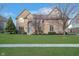 Stately brick home with a well-kept lawn and landscaping, offering curb appeal at 9880 Wading Crane Ave, Fishers, IN 46055