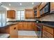 A modern kitchen featuring stainless steel appliances, granite counters, and wooden cabinets with ample storage space at 9880 Wading Crane Ave, Fishers, IN 46055