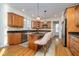 A kitchen featuring granite counters, wooden cabinets, an island with barstool seating, and stainless steel appliances at 9880 Wading Crane Ave, Fishers, IN 46055