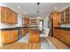 A spacious kitchen boasts wooden cabinets, granite counters, stainless steel appliances, and an island with barstool seating at 9880 Wading Crane Ave, Fishers, IN 46055