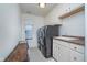 Laundry room with front loading washer, dryer, sink, and cabinets at 9880 Wading Crane Ave, Fishers, IN 46055