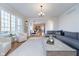 Spacious living room with large windows, hardwood floors, and an open layout to the dining area at 9880 Wading Crane Ave, Fishers, IN 46055