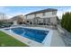 Private backyard oasis with a sparkling pool, fire pit, outdoor kitchen, and lush landscaping at 9880 Wading Crane Ave, Fishers, IN 46055