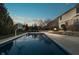 Backyard swimming pool with basketball hoop next to patio with fire pit and outdoor seating at 9880 Wading Crane Ave, Fishers, IN 46055