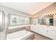 Bathroom with soaking tub, glass-enclosed shower, and double vanity at 10516 Beacon Ln, Indianapolis, IN 46256