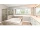 Bathroom with soaking tub, glass-enclosed shower, and double vanity at 10516 Beacon Ln, Indianapolis, IN 46256