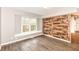 Bedroom with accent wall, light gray walls, hardwood floors, and window at 10516 Beacon Ln, Indianapolis, IN 46256