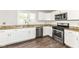 Kitchen featuring stainless steel appliances, white cabinets, granite counters, and hardwood floors at 10516 Beacon Ln, Indianapolis, IN 46256