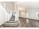 Open-concept living room features hardwood floors, staircase, and natural light at 10516 Beacon Ln, Indianapolis, IN 46256
