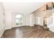 Inviting living room featuring hardwood floors, a large window, and natural light at 10516 Beacon Ln, Indianapolis, IN 46256