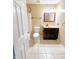 Well-lit bathroom featuring vanity with dark wood cabinet, toilet, and shower-tub combination at 10711 Regis Ct, Indianapolis, IN 46239