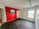 Spacious bedroom with hard surface floors, a bright red accent wall and ample natural light at 10711 Regis Ct, Indianapolis, IN 46239