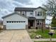 Charming two-story home with brick accents, attached two-car garage and well-maintained front yard at 10711 Regis Ct, Indianapolis, IN 46239