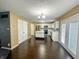 Modern kitchen with white cabinets, stainless steel appliances, and an island, open to the dining area at 10711 Regis Ct, Indianapolis, IN 46239