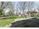 Expansive backyard featuring a gazebo, deck, grassy lawn, and storage shed, perfect for outdoor enjoyment and storage at 10944 Echo Trl, Indianapolis, IN 46236