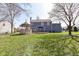 Backyard featuring a well-maintained lawn, gazebo, and views of the home's exterior, blending indoor-outdoor living at 10944 Echo Trl, Indianapolis, IN 46236