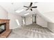 Carpeted bedroom with fireplace, ceiling fan, and natural light provided by skylights and windows at 10944 Echo Trl, Indianapolis, IN 46236