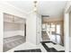 Inviting foyer with black and white tile floors leads to the living spaces and staircase with white railing at 10944 Echo Trl, Indianapolis, IN 46236