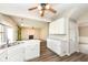 This kitchen features white cabinets, updated appliances, and a view to the dining and living room at 10944 Echo Trl, Indianapolis, IN 46236
