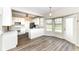 Bright kitchen features white cabinetry, appliances, and an eat-in area with large windows offering lots of natural light at 10944 Echo Trl, Indianapolis, IN 46236