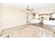 Bright living room with neutral walls, carpet flooring, and view of the staircase and kitchen at 10944 Echo Trl, Indianapolis, IN 46236