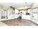 Spacious living room offers neutral walls, wood flooring, and open access to a kitchen and staircase at 10944 Echo Trl, Indianapolis, IN 46236