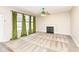 Bright living room features neutral walls, carpet flooring, fireplace, and view of backyard through three windows at 10944 Echo Trl, Indianapolis, IN 46236