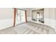 Well-lit living room showcases wall paneling, neutral carpet, and an open view of the entryway at 10944 Echo Trl, Indianapolis, IN 46236