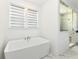 A modern bathroom featuring a freestanding tub, bright light and walk-in shower at 11392 Gammel Pl, Fishers, IN 46040