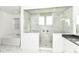 A modern bathroom featuring a marble walk-in shower, tub and white fixtures at 11392 Gammel Pl, Fishers, IN 46040